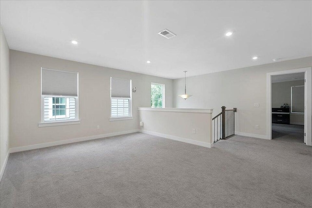 empty room with light carpet and a wealth of natural light