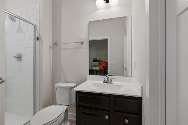 bathroom featuring vanity, toilet, and a shower with door