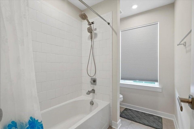 bathroom featuring toilet, tile patterned flooring, and shower / tub combo with curtain