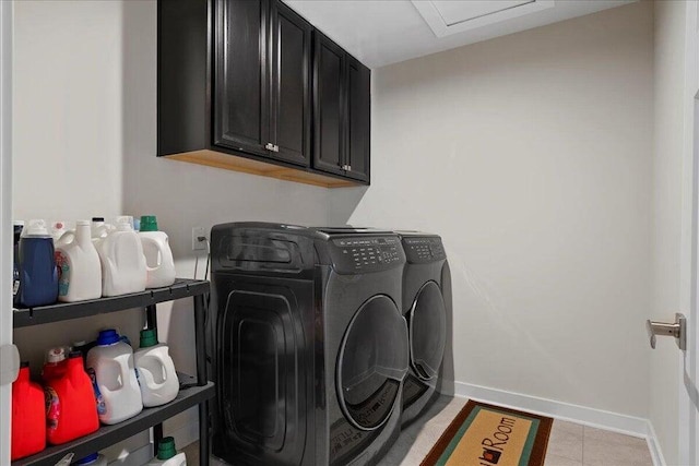 washroom featuring washer and clothes dryer, light tile patterned floors, and cabinets