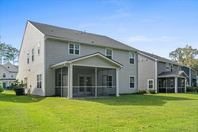 back of house featuring a sunroom, a yard, and central AC unit