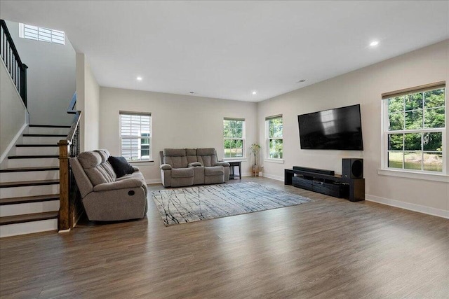 living room with a healthy amount of sunlight and dark wood-type flooring