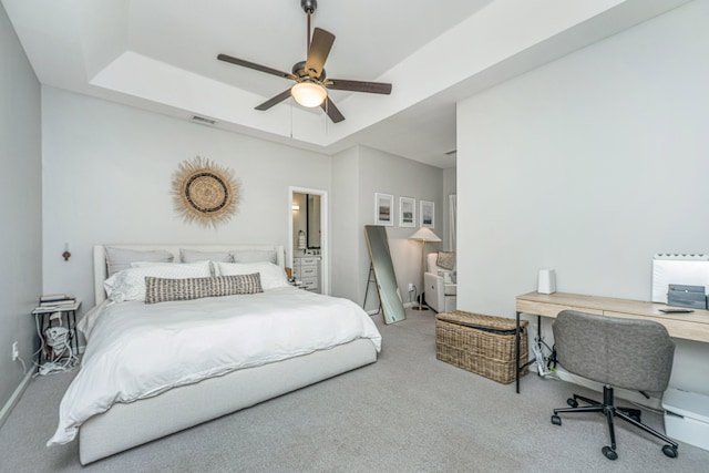 bedroom with ceiling fan, a raised ceiling, and carpet floors