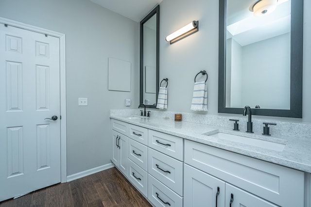 bathroom with hardwood / wood-style floors and vanity