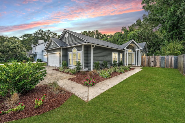 ranch-style house featuring a yard and a garage