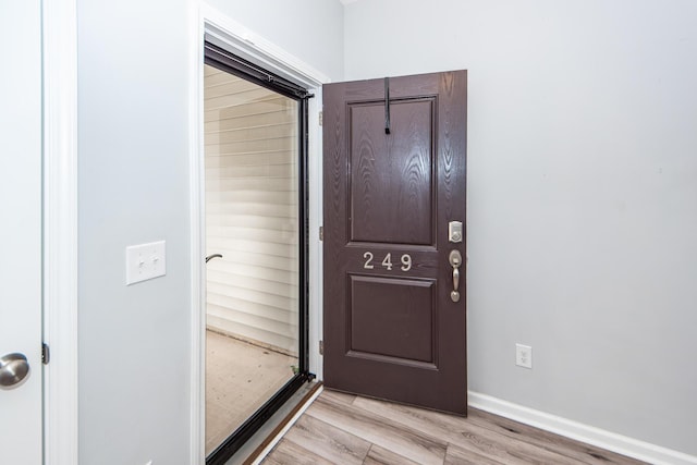 doorway to outside with light hardwood / wood-style flooring