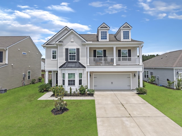 view of front of home featuring an attached garage, a front yard, concrete driveway, a standing seam roof, and roof with shingles