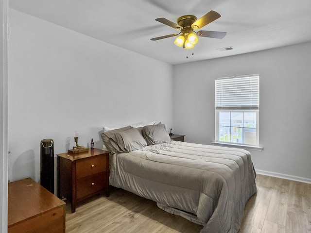 bedroom with light wood-type flooring and ceiling fan