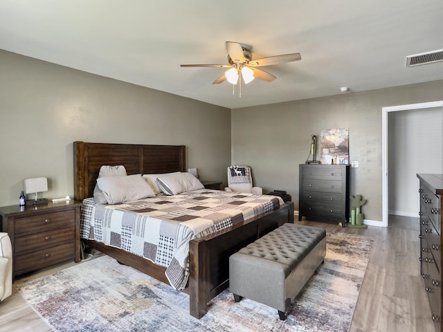 bedroom with wood finished floors, ceiling fan, and baseboards