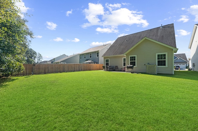 back of property featuring a lawn