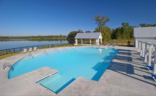 view of pool featuring a patio area and a water view