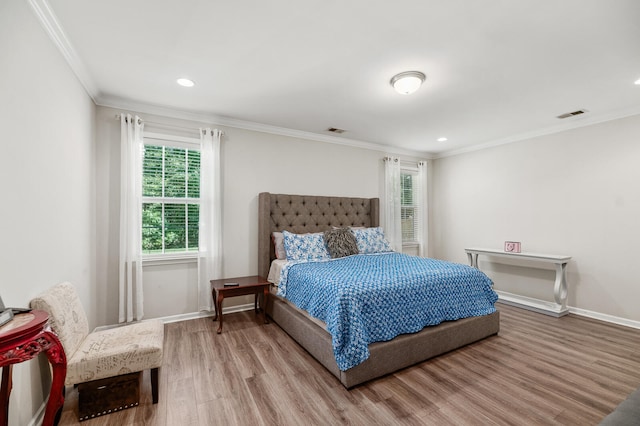 bedroom featuring light wood-type flooring and ornamental molding