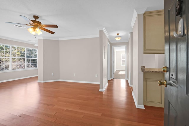 interior space featuring ornamental molding, hardwood / wood-style floors, and ceiling fan