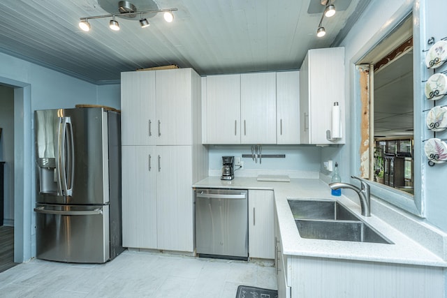 kitchen featuring white cabinets, sink, rail lighting, wood ceiling, and stainless steel appliances