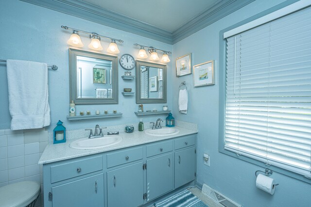 bathroom featuring crown molding, vanity, tile walls, and toilet