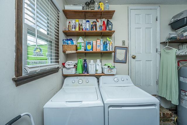 laundry room with independent washer and dryer, a textured ceiling, and water heater