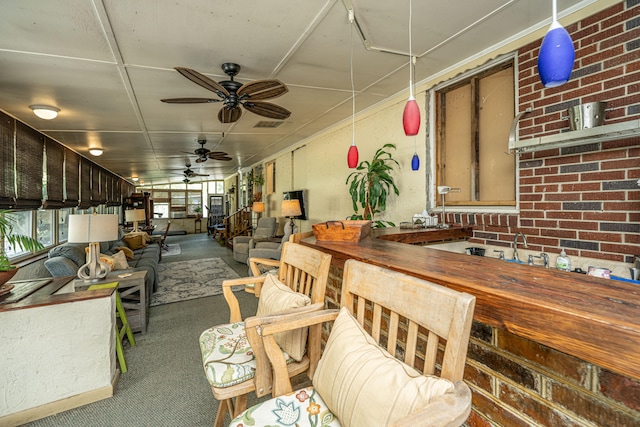 interior space featuring ceiling fan and carpet