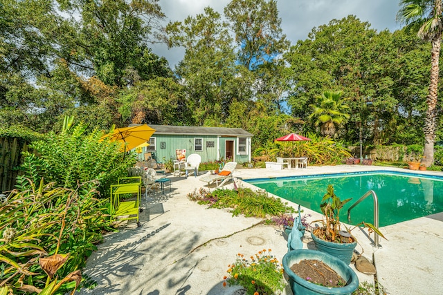 view of pool with a patio area and an outdoor structure