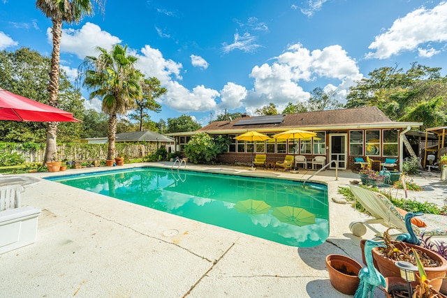 view of pool with a patio and a sunroom