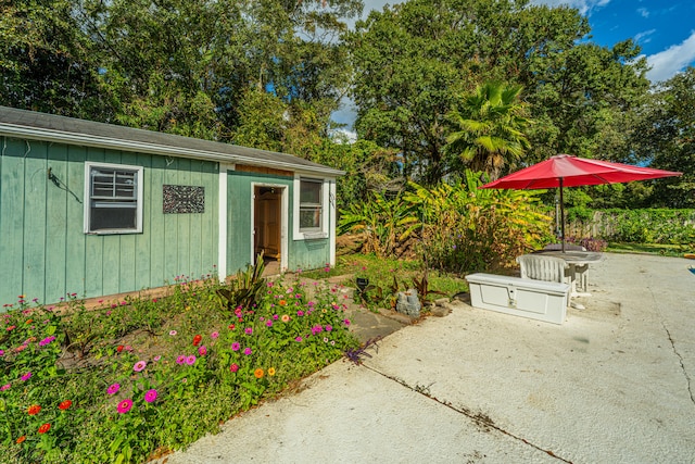 view of patio with an outbuilding