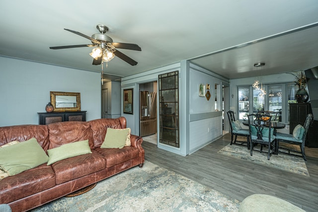 living room featuring wood-type flooring and ceiling fan