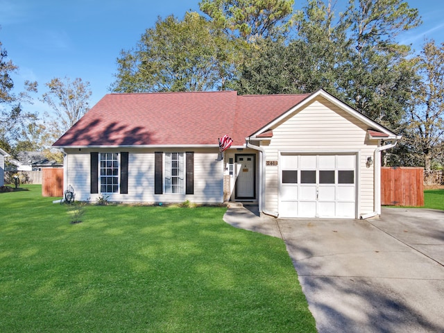 ranch-style house featuring a garage and a front lawn