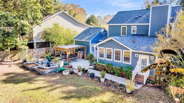 back of property with a patio area and a yard