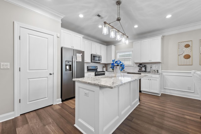 4319 Bream Rd, Charleston, SC 29418 - kitchen with appliances with stainless steel finishes, crown molding, white cabinetry, dark wood-style flooring, and a center island