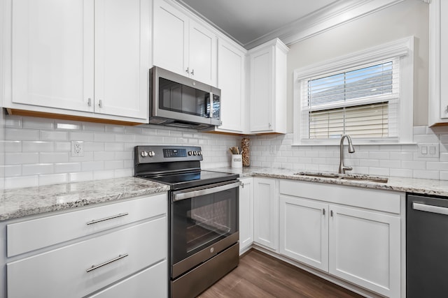 4319 Bream Rd, Charleston, SC 29418 - kitchen featuring appliances with stainless steel finishes, crown molding, white cabinets, tasteful backsplash, and dark wood-type flooring
