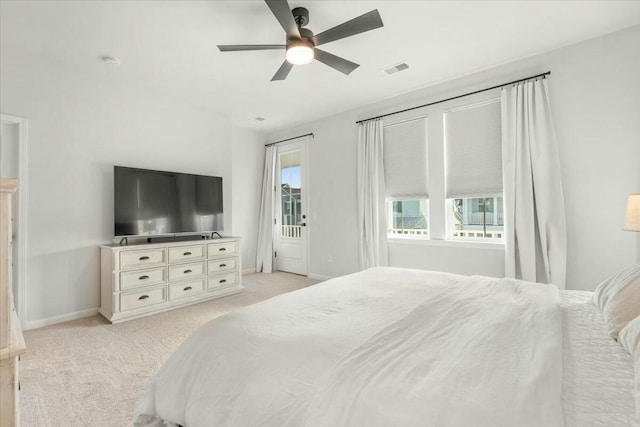 bedroom with light carpet, ceiling fan, access to exterior, and multiple windows