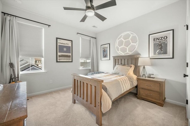 bedroom with ceiling fan and light carpet