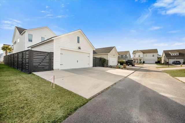 view of property exterior with a garage and a lawn