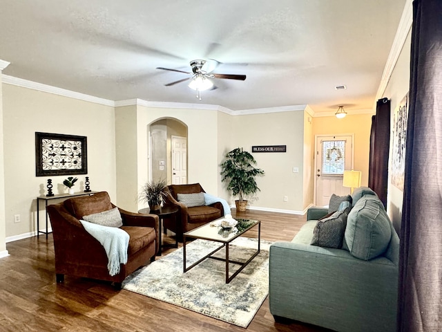 living room featuring ceiling fan, dark hardwood / wood-style flooring, and ornamental molding