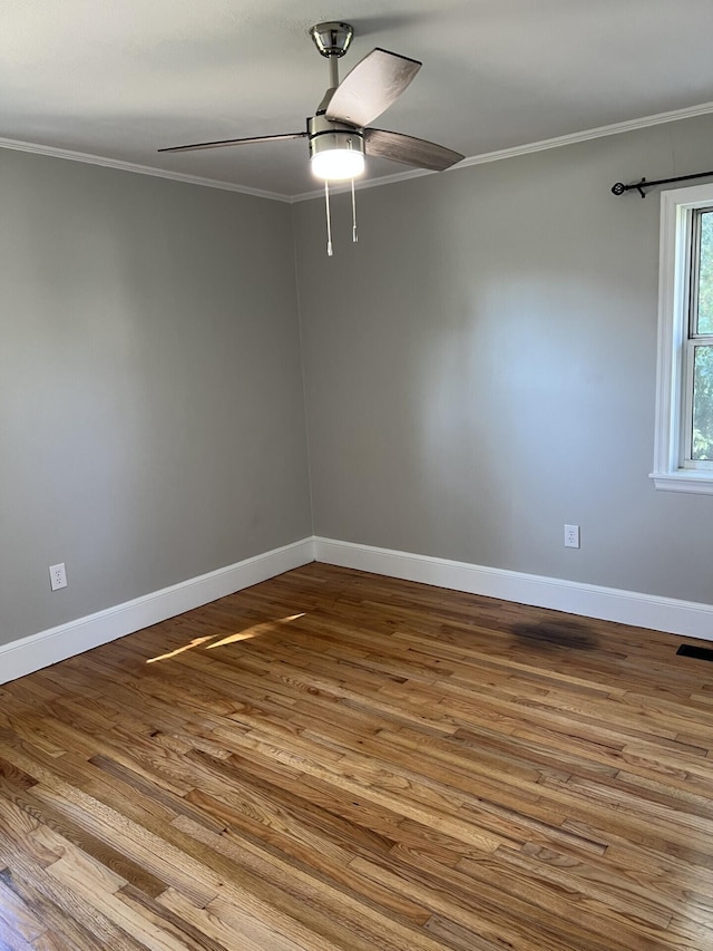 unfurnished room with a ceiling fan, light wood-type flooring, crown molding, and baseboards