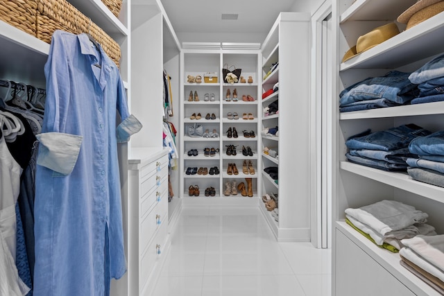 spacious closet with light tile patterned floors