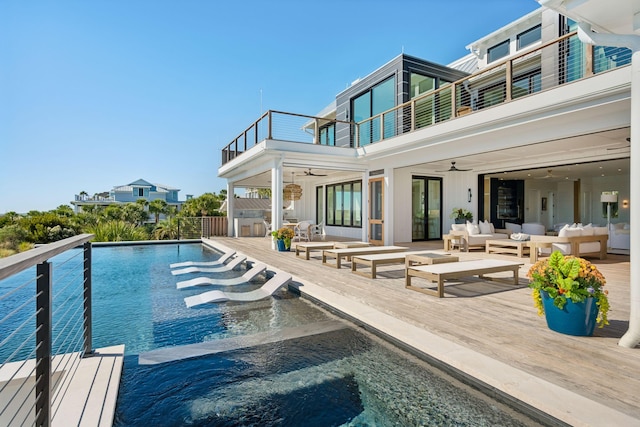 view of swimming pool with an outdoor hangout area and ceiling fan