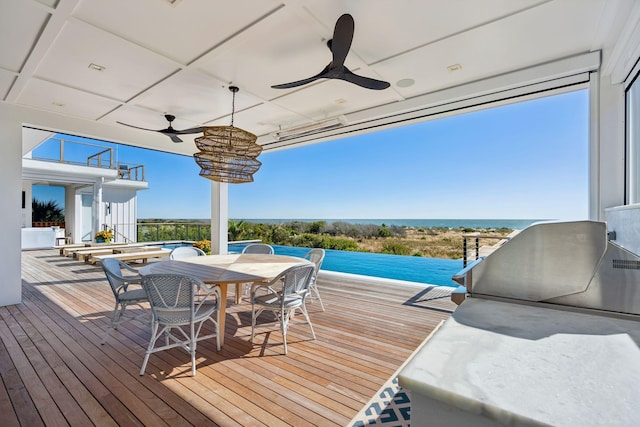 wooden deck with ceiling fan and a water view