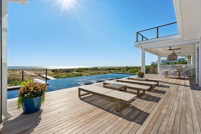 wooden terrace with ceiling fan and a swimming pool