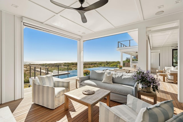 sunroom / solarium featuring ceiling fan and plenty of natural light