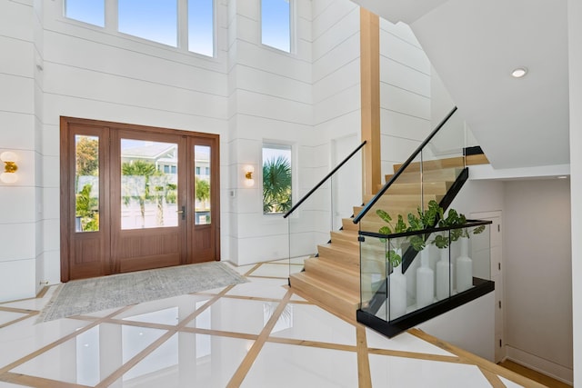 foyer featuring a towering ceiling