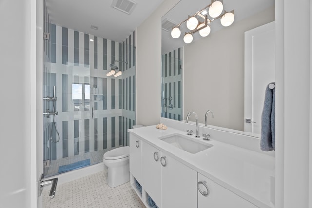 bathroom with vanity, toilet, and tiled shower