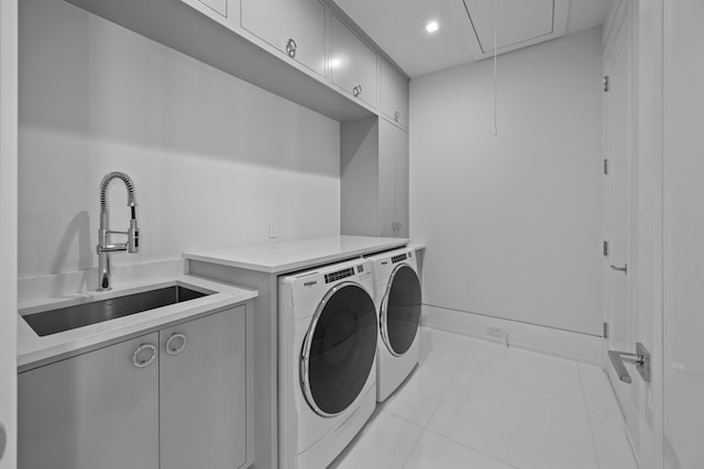 washroom with washing machine and clothes dryer, light tile patterned flooring, cabinets, and sink