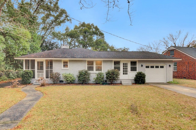 single story home featuring a sunroom, a garage, and a front lawn