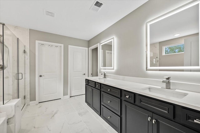 full bath featuring marble finish floor, a shower stall, visible vents, and a sink