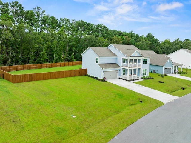 view of front of property with a front yard, fence, and driveway