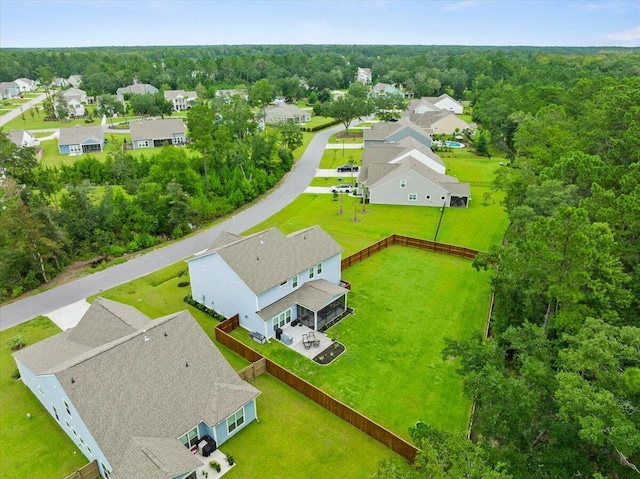 birds eye view of property featuring a residential view and a view of trees