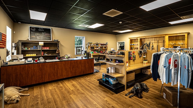 office with a paneled ceiling and wood-type flooring