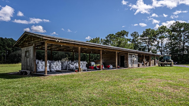 exterior space featuring a lawn and an outdoor structure