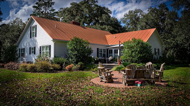 rear view of property with a patio area and a yard