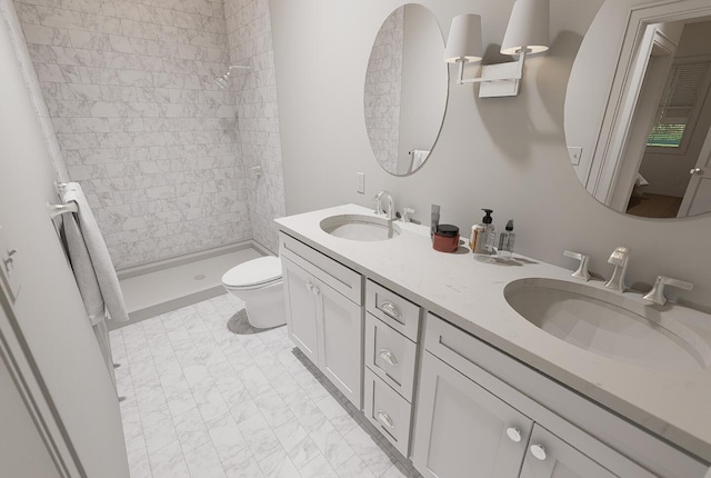 bathroom featuring tiled shower, vanity, and toilet